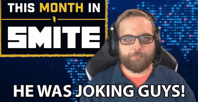 a man wearing headphones sits in front of a sign that says this month in smite