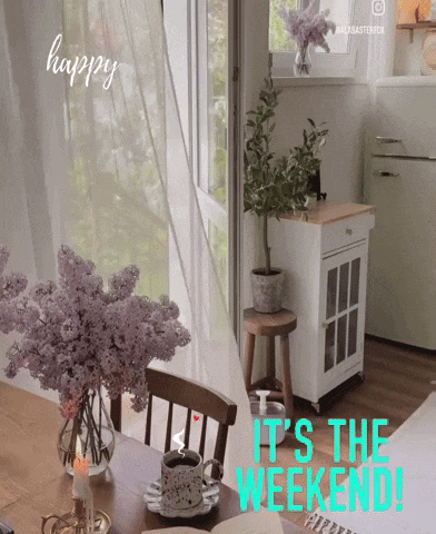 a sign that says it 's the weekend with flowers on the table
