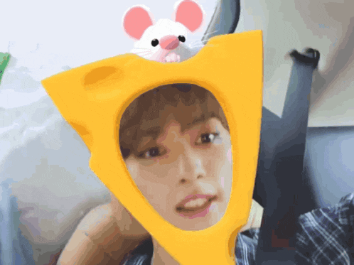 a person wearing a yellow hat with a mouse on it