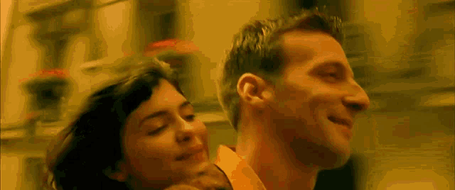 a man and a woman are standing next to each other and smiling