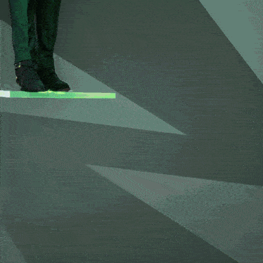 a person in green pants and a black coat