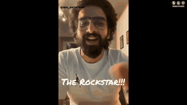 a man with a beard wearing glasses and a white shirt says the rockstar
