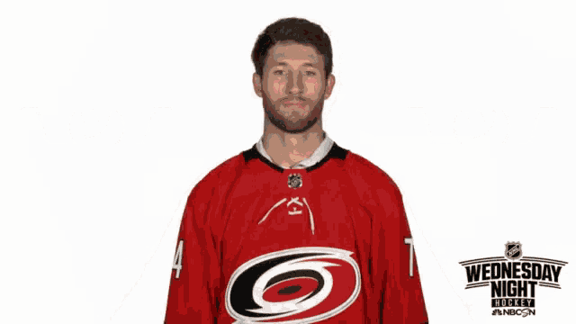 a hockey player wearing a red jersey with the number 4 on it