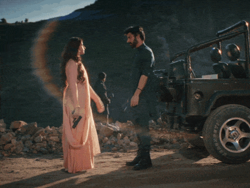 a man with a beard and mustache looks at a woman