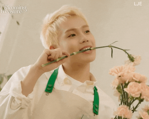 a young man is holding a flower in his mouth and the words blooming treasure are on the bottom