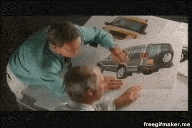 two men are looking at a drawing of a car and the words freegifmaker.me are on the bottom of the screen