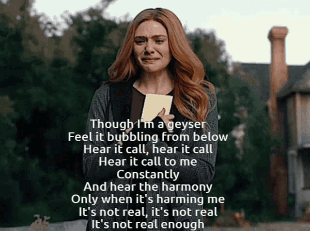 a woman is crying while holding a piece of paper