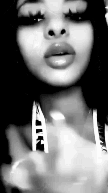 a close up of a woman 's face in a black and white photo .