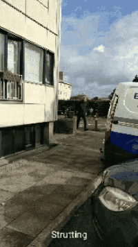 a white van with the letter e on it is parked on the side of the road