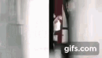 a blurry picture of a person walking in a doorway .
