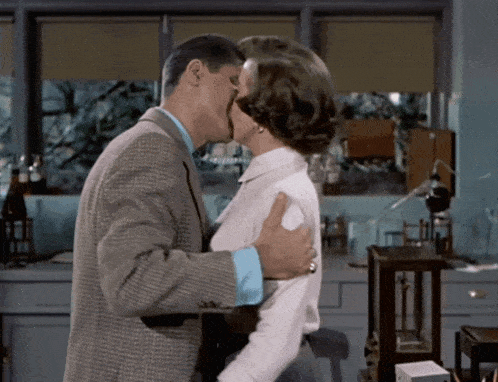a man and a woman are kissing in a lab