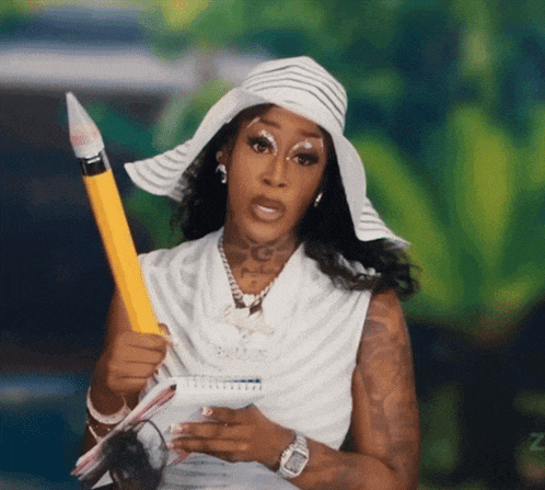 a woman wearing a hat and holding a pencil with the letter z on the bottom