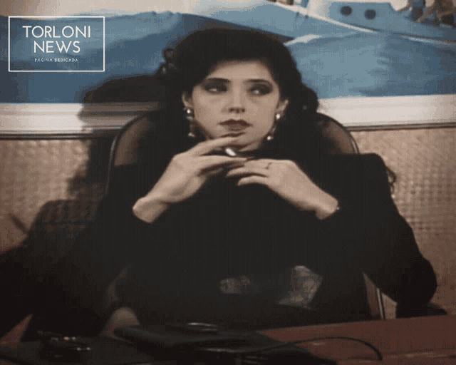 a black and white photo of a woman with the words torloni news on the top