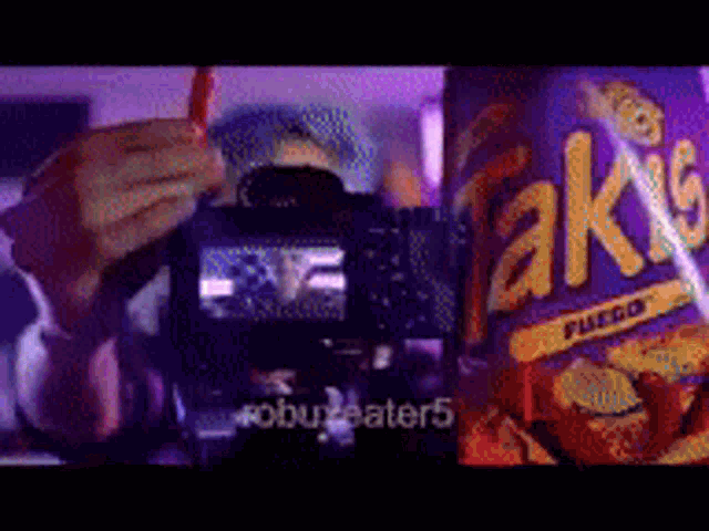 a person is taking a picture of a bag of takis fuego