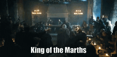 a crowd of people are gathered in a room with the words " king of the marths " written on the bottom