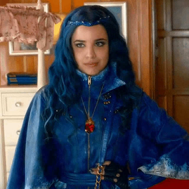 a woman with blue hair is wearing a blue jacket and gloves .