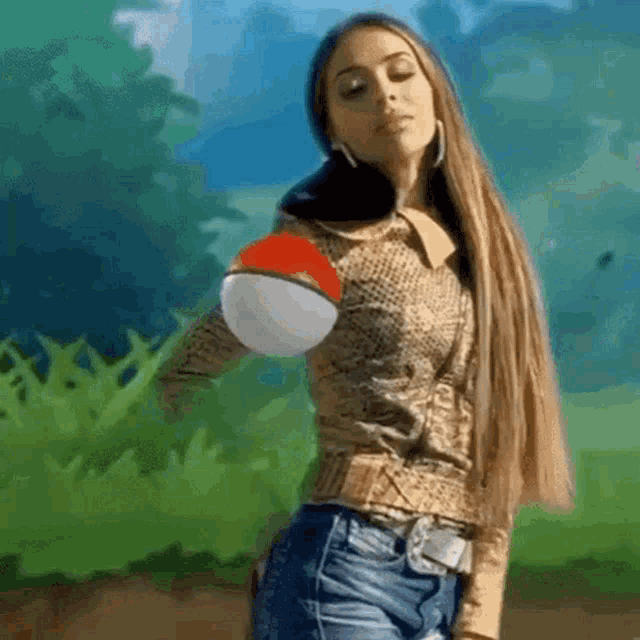 a woman is holding a pokemon ball in her hand