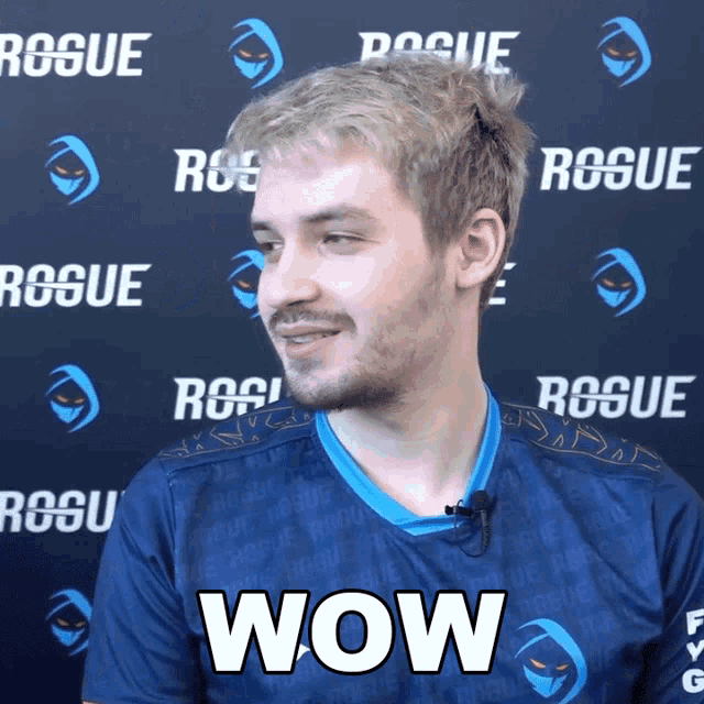 a man wearing a blue shirt that says wow on it