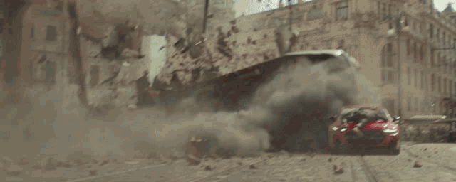 a red car is driving down a destroyed street