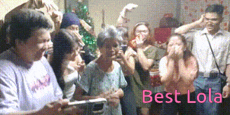 a group of people standing in a room with the words best lola written in pink