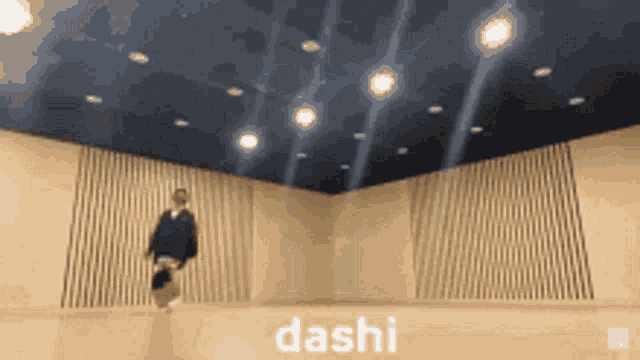 a person is jumping in the air in a room with the word dashi written on it