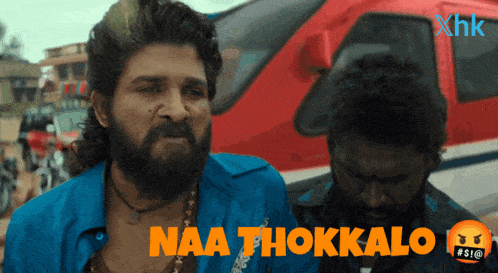 a man with a beard says naa thokkalo in front of a helicopter