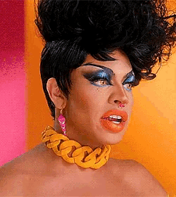 a drag queen wearing a yellow chain necklace