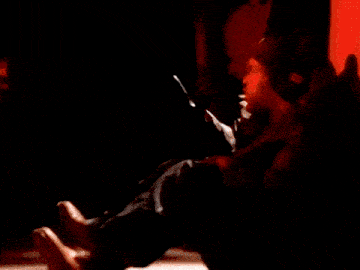 a close up of a man 's face in a dark room