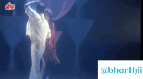 a blurred image of a man and woman dancing in front of a banner that says ultra