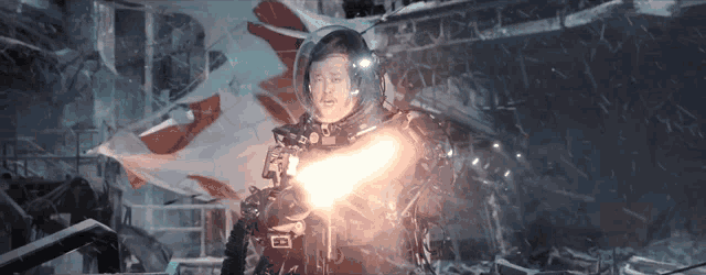 a man in a space suit is holding a light beam
