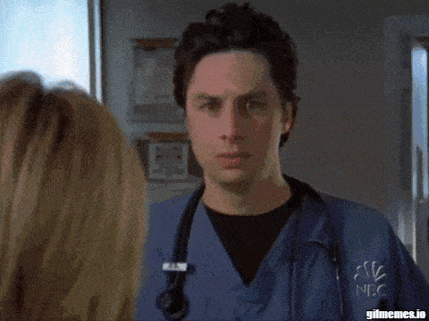 two women in lab coats are dancing in a hallway with gifmemes.io written on the bottom right