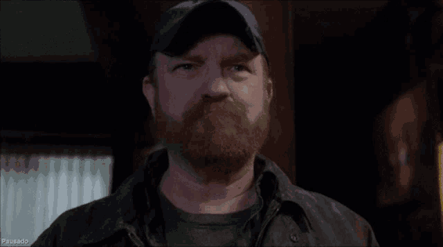 a man with a beard says " balls " in front of him