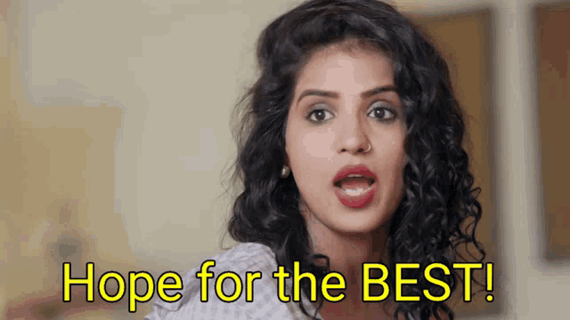 a woman says " hope for the best " in front of her
