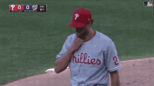 a phillies baseball player is standing on the field during a game