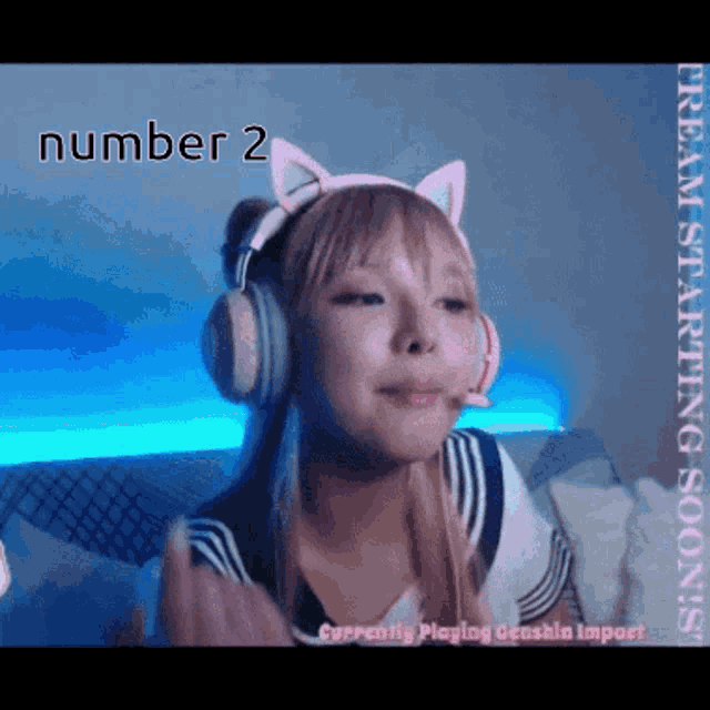 a girl wearing headphones and a cat ear headband with the number 2 written on it