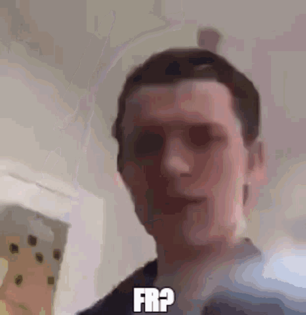 a man is making a funny face and says `` fr ? '' in a blurry photo .