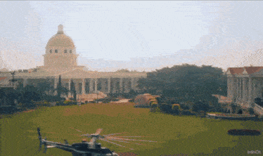 a helicopter is flying over a large building