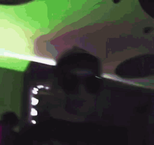 a blurry picture of a person wearing sunglasses