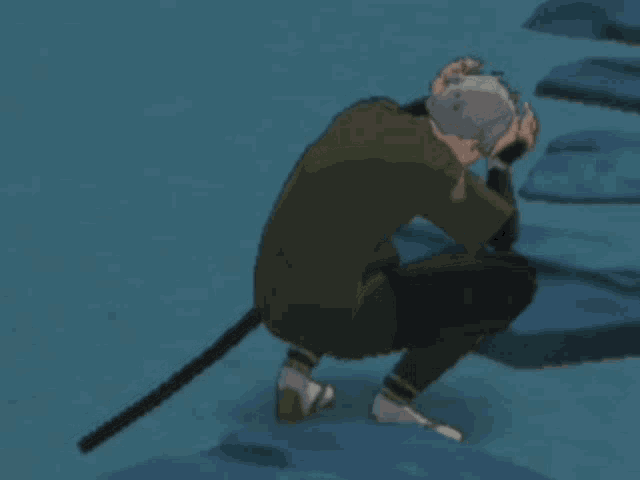 a man in a green shirt is kneeling down with a sword in his hand