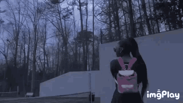 a girl with a pink backpack is walking on a tennis court with imgplay written below her