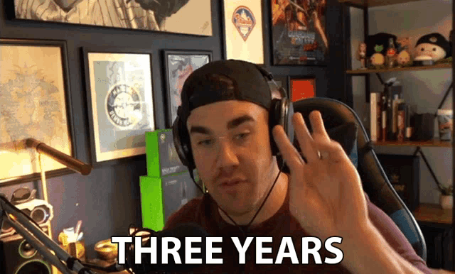 a man wearing headphones says three years