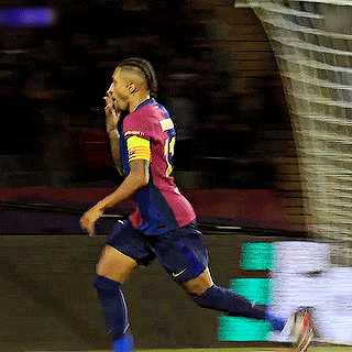 a soccer player wearing a number 19 jersey is running towards the goal