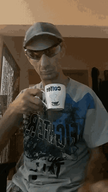 a man wearing a hat and sunglasses is holding a coffee mug that says coffee