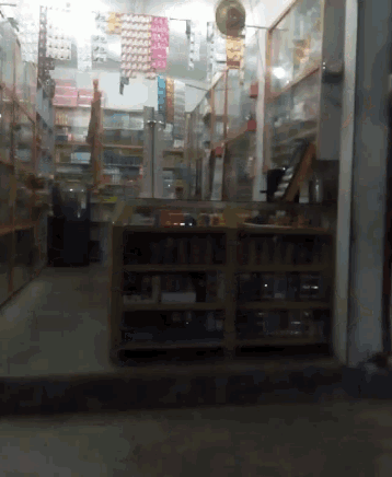 the inside of a store with lots of shelves and a fan