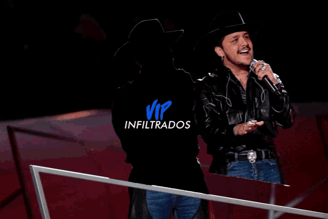 a man wearing a cowboy hat and leather jacket sings into a microphone