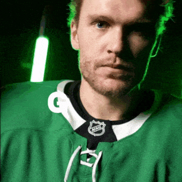 a hockey player wearing a green jersey with the letters nnl on it