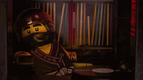 a lego ninjago character wearing headphones and a helmet with the letter a on it