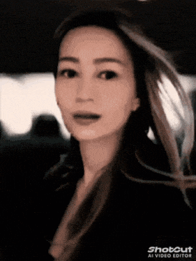a woman 's face is shown in a shot cut video