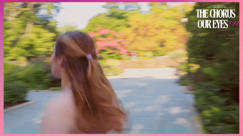 a woman is walking down a path with the words " the chorus our eyes " behind her