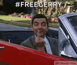mr bean is giving the middle finger while driving a car .